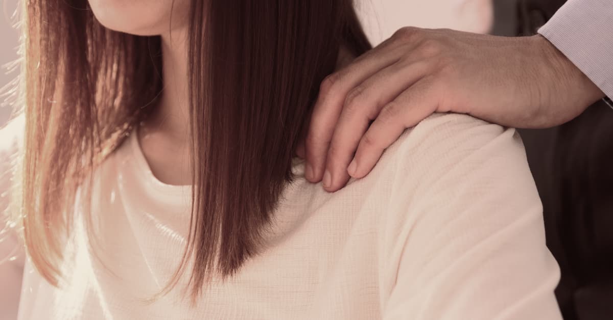 Man with hand on woman's shoulder depicting sexual assault practice area for Alexander Shunnarah Trial Attorneys