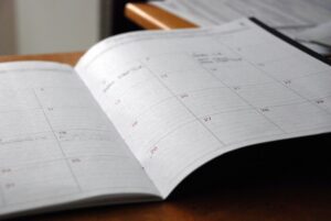 A calendar with multiple dates marked, illustrating the car accident lawsuit timeline.
