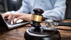 An attorney reviews medical records and case documents. This is the kind of investigation a Phoenix medical malpractice lawyer conducts to prove negligence.