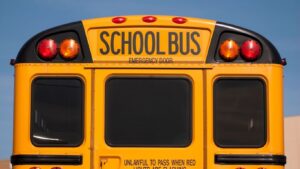 A close-up of a yellow American school bus. Bus accident lawsuits may involve multiple liable parties, including drivers, companies, and government agencies.