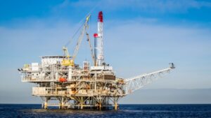 An offshore oil rig at sea with safety equipment visible; this is the kind of demanding work environment where common oil rig injuries occur.