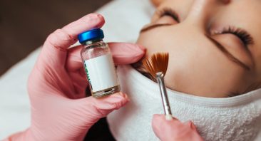 in the hands of a brush and a container with the drug, cosmetology chemical peeling