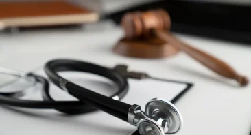 A stethoscope and gavel sit on a medical malpractice attorney's desk in Alabama.