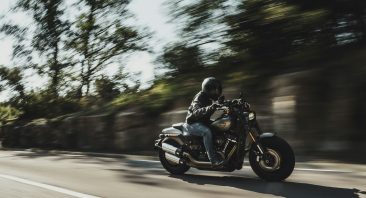 A motorcyclist makes a sharp turn on an interstate. If they wreck, they made need an Alabama motorcycle accident attorney.
