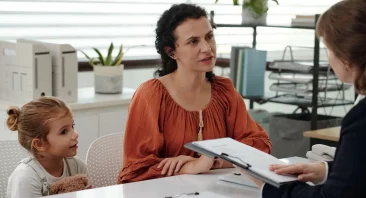 A grieving Birmingham family meets with a wrongful death lawyer at a law office to discuss their legal options after losing a loved one.