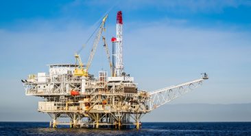 An offshore oil rig at sea with safety equipment visible; this is the kind of demanding work environment where common oil rig injuries occur.