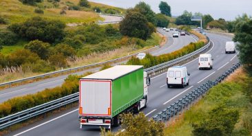 A series of delivery trucks travel on a highway, transporting multiple goods. Delivery truck accidents involving UPS, FedEx, and Amazon vehicles may involve multiple liable parties.