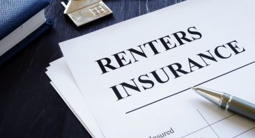 A renters insurance policy document beside apartment keys, illustrating whether renters insurance covers personal injury.