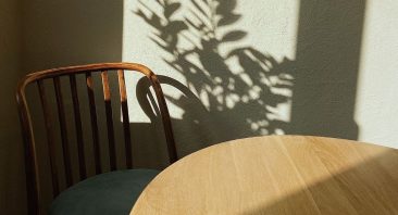 A single empty chair at a family dinner table, symbolizing a wrongful death claim after a fatal car accident.
