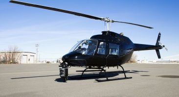 A private helicopter sits on empty tarmac, illustrating the type of scenario that precursors a helicopter accident lawsuit.