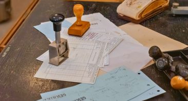 Claims estimates on a desk with stamps, portraying the process to file a property damage claim.