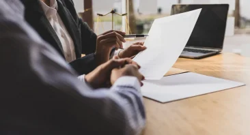 A Montgomery personal injury attorney reviews case documents with an injured client during a free consultation.