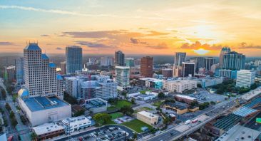 An aerial view of downtown Orlando with multiple lanes and traffic signals. This is the kind of high-traffic crossing where dangerous intersection crashes occur.