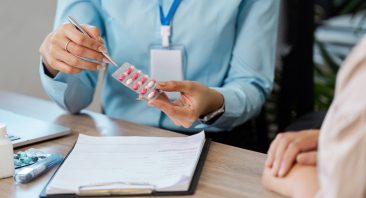 In a consultation, a healthcare provider explains the prescribed medication to a patient, ensuring clarity and understanding of the treatment plan.