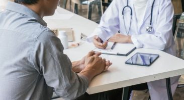 A doctor meets with a patient to answer the question of "What is maximum medical improvement?"
