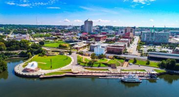 The photo is an overhead photo of the Montgomery skyline, conveying the local power of a Montgomery personal injury attorney.