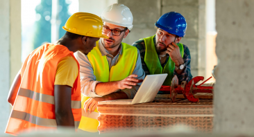 Two construction workers discuss an incident with another coworker, illustrating what to do after a construction accident at work.