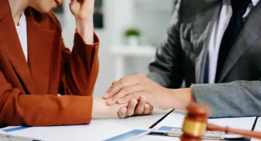 A Huntsville, AL accident lawyer reviews case details with an injured client at a law office near Redstone Arsenal.